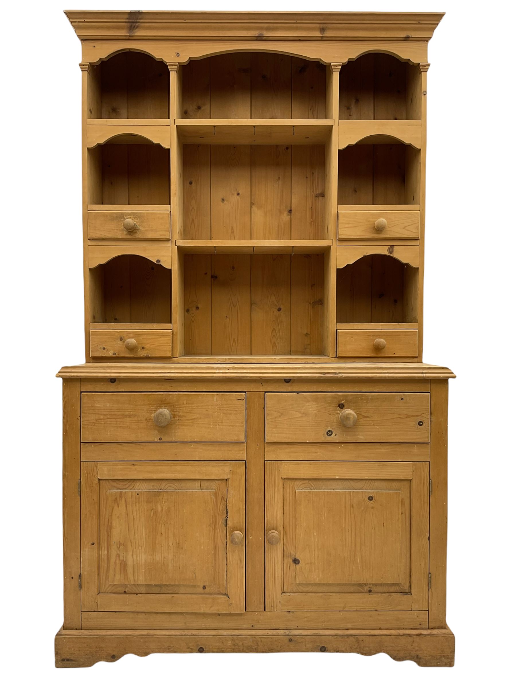 Solid pine dresser, raised plate rack fitted with small drawers over two drawers and double cupboard, plinth base