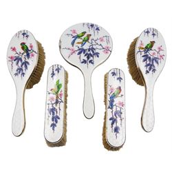 1920's five piece silver mounted and enamel dressing table set, comprising pair of hair brushes, pair of clothes brushes, and hand held mirror, each decorated verso with birds perched upon blossoming branches, hallmarked Henry Clifford Davis, Birmingham 1927 and 1928 


