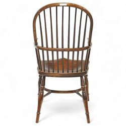 Late 19th century ash and elm Windsor armchair, with hooped back and spindle supports, shaped elm saddle seat, on turned legs united by crinoline stretcher