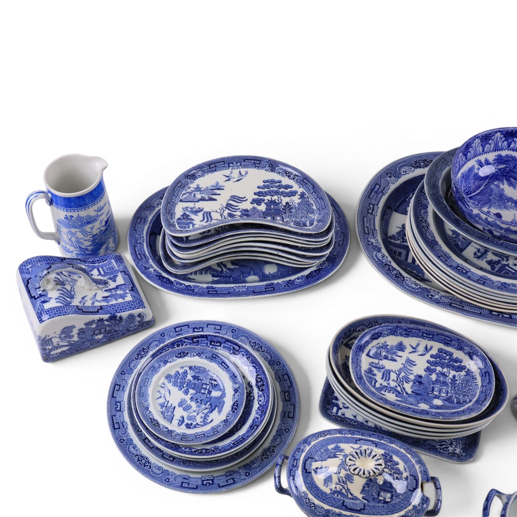 Collection of blue and white dinner wares, mainly Wedgwood Willow pattern, including serving platter, dinner plates etc   
