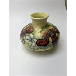 A Moorcroft vase, circa 1950, of squat bulbous form, decorated in the Orchid pattern upon a yellow glazed ground, with impressed and blue painted WM initials for Walter Moorcroft, H10.5cm. 