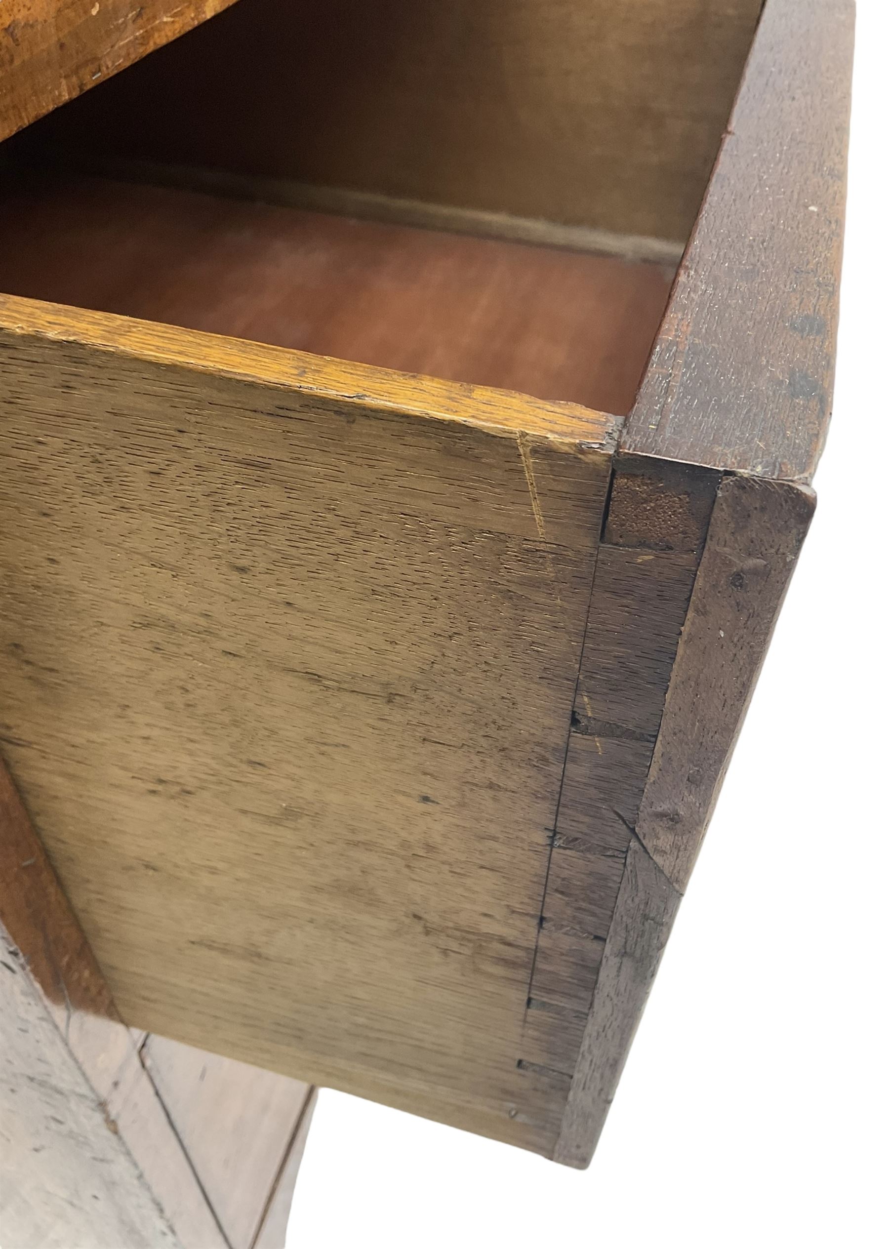 19th century mahogany linen press, projecting moulded cornice over figured frieze, enclosed by two panelled doors with geometric stringing, fitted with two short and one long cock-beaded drawers, on shaped apron and splayed bracket feet