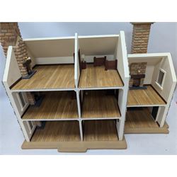1:24 scale stone effect three-storey cottage dolls house, with green arched door and lattice effect windows, decorated to the interior with wooden floors, wired lighting and fire places, H45cm, W57cm, D26cm