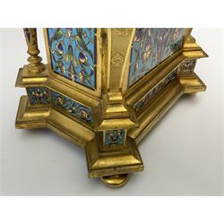 19th century French ormolu and champlevé enamel mantel clock, the twin handled urn with fruit and flower cast finial on cushion top, each corner set with urn, the front canted corners decorated with winged caryatid figures, turquoise ground champlevé work with scrolling floral pattern, twin train movement striking on bell by Japy Freres