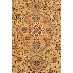  Fine Persian rug, beige field with trailing stylised flower heads and foliage, blue ground border with scroll decoration, 280cm x 180cm  