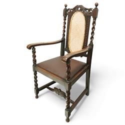 Victorian Jacobean revival oak carver chair, carved scroll cresting rail over an oval back panel later caned, open arms on barley-twist supports, padded seat, raised on spiral turned legs united by a shaped front stretcher
