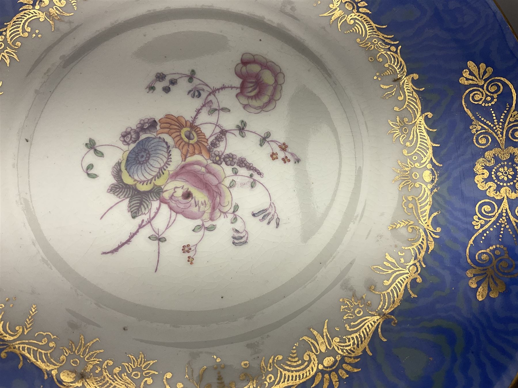 Set of three Victorian teacups and saucers, with matching dessert plate, decorated with a watered silk blue boarder and hand painted floral sprays to the centre 