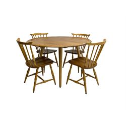 Ercol - circular drop leaf table on splayed tapering supports; together with four dining chairs