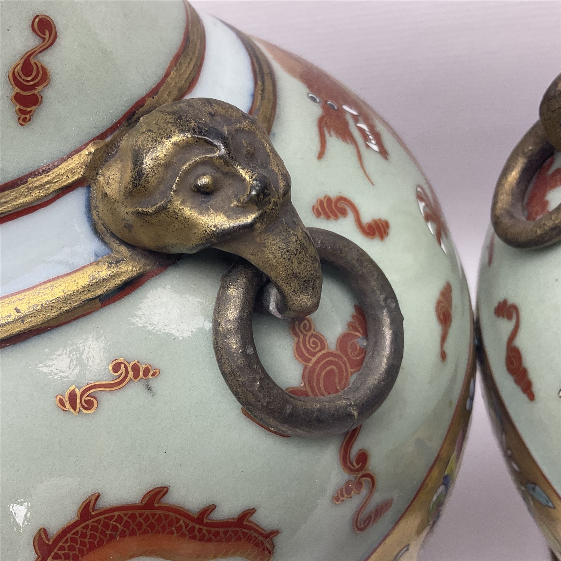 Pair of early 20th century Chinese vases decorated with dragons chasing a flaming pearl, with a gilt border of butterflies and floral sprigs, with Elephant head handles, H44cm 