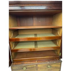 George III mahogany linen press cupboard, projecting moulded cornice over two panelled doors, the interior fitted with two slides and shelf, two short and two long drawers below, shaped apron over bracket feet 