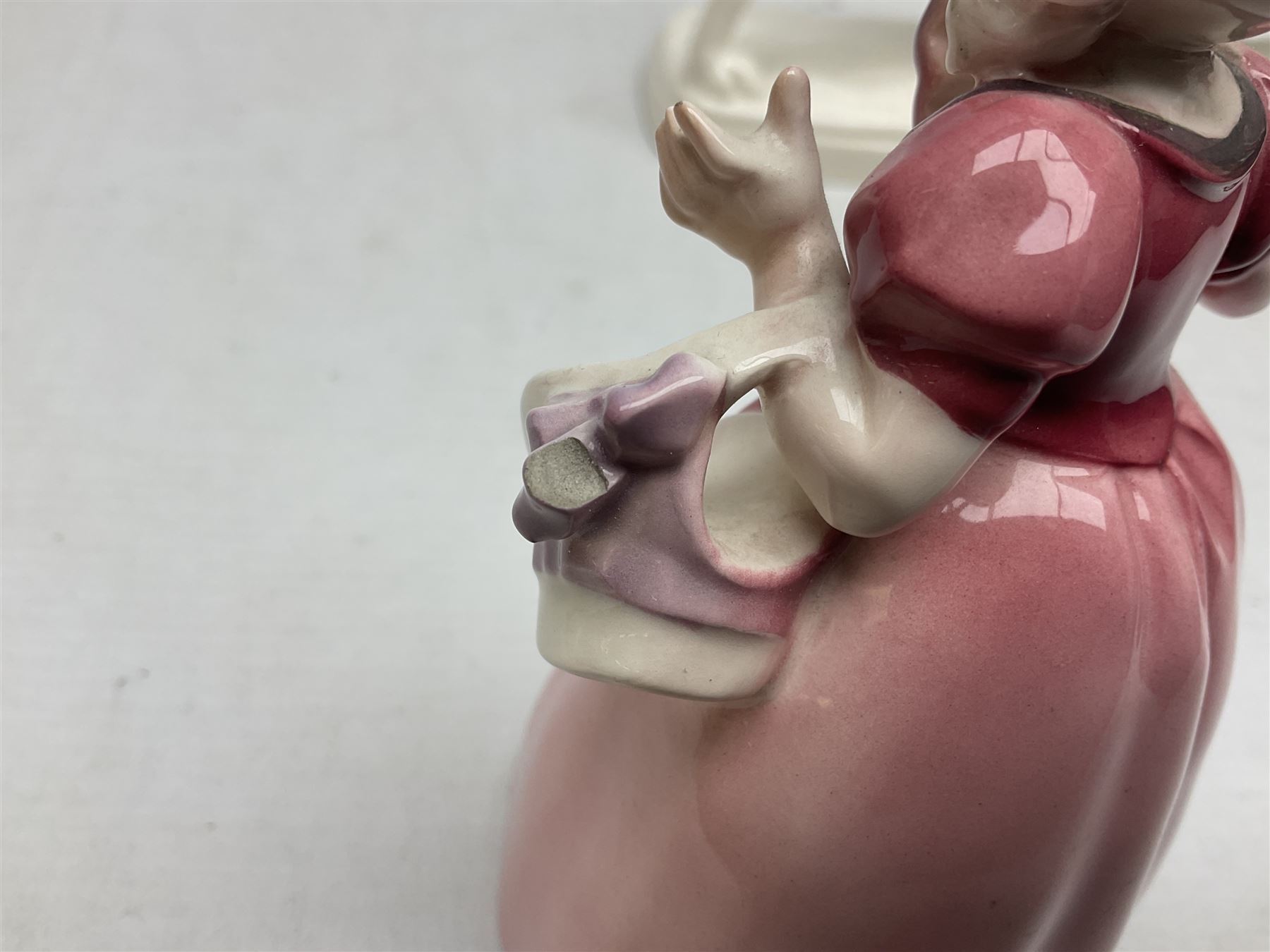 Early 20th century Katzhütte figure of a pointer dog, and figure of a young girl holding basket and fan, both with green cat H house printed mark beneath, dog L25cm