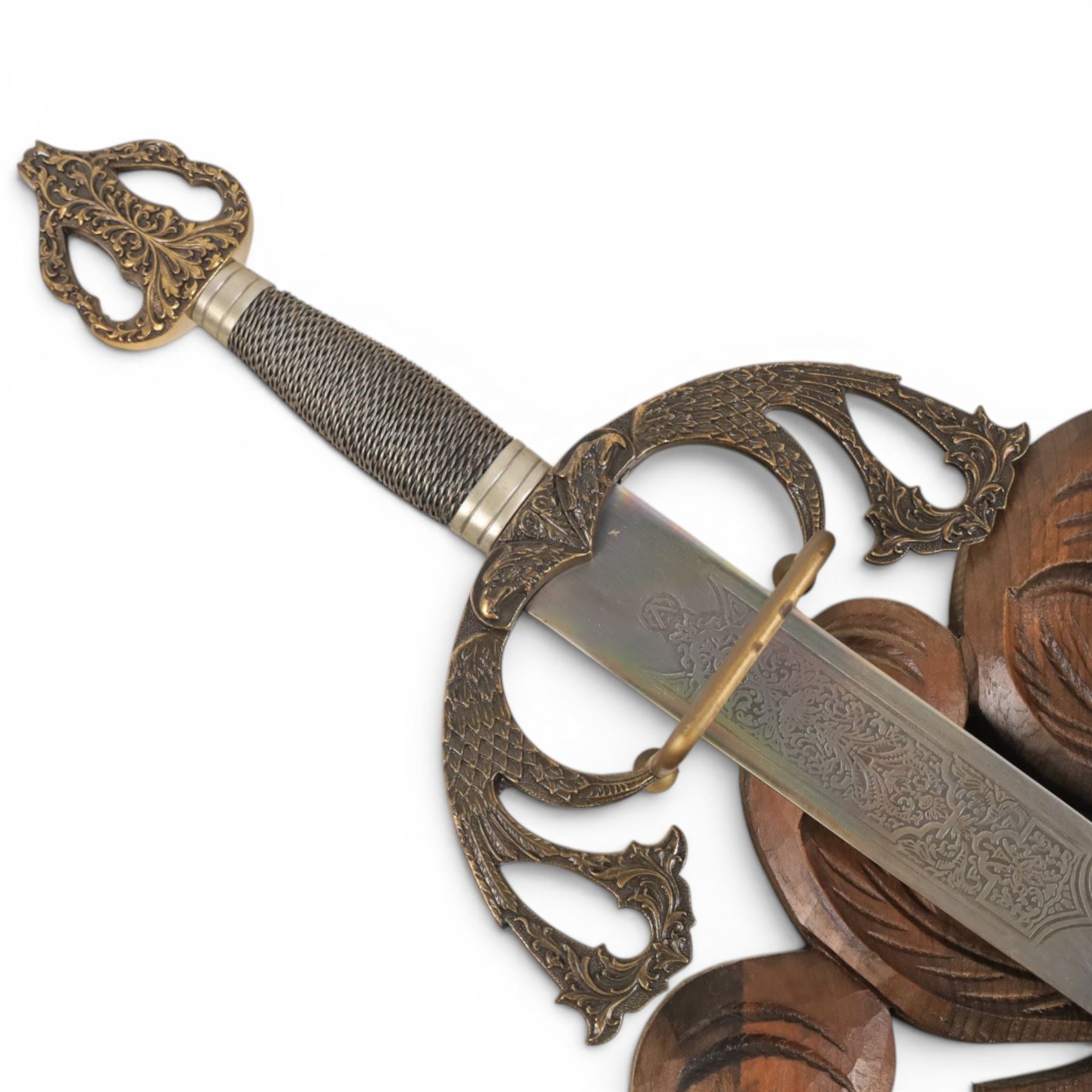 Carved wooden wall plaque, decorated with foliate scrolls, with two reproduction swords attached, together with five other wooden plaques with foliate scrolls and shields