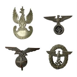 Three WW2 German visor cap badges comprising Police eagle, Political leaders eagle and Norwegian Quisling Party; all with fixings; and WW2 Polish visor cap badge (4)