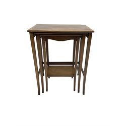 Waring & Gillow - nest of three mahogany occasional tables, rectangular crossbanded top with ebony stringing, raised on tapered supports united by stretcher, the smallest with undertier
