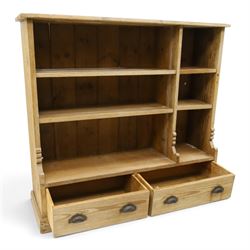 Late Victorian stripped pitch pine open bookcase, fitted with four adjustable open shelves, two drawers fitted to base with pull handles, on skirted base 