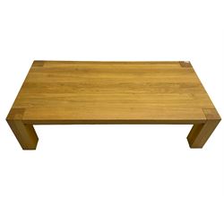Light oak coffee table, rectangular top over square supports