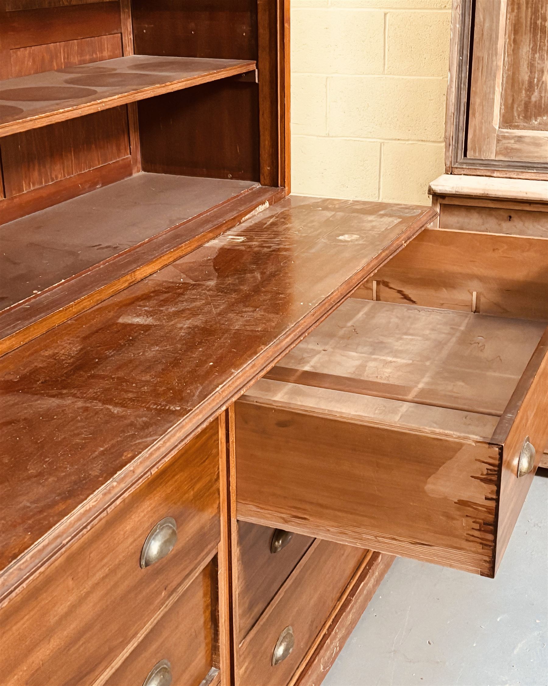 Large mahogany haberdashery cabinet shop fitting, early 20th century and later, the top section fitted with nine shelves, above nine deep drawers sliding out on rollers, on a skirted base. Disassembles for transport. H237cm, L373cm, D95cm.  - COLLECTION BY APPOINTMENT FROM: The White House, Thirsk Road, Easingwold, York, YO61 3NF - CALL 01723 507111 TO ARRANGE