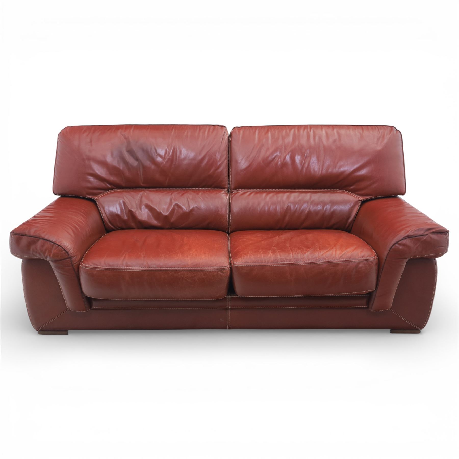 Fabrizio Mantellassi - 20th century Italian red leather suite, one three seat and two large armchairs, upholstered in deep red hide with stitched seam detailing, with magazine pockets to each side, the rectangular back cushions above broad padded arms and seat cushions, raised on low block bases

Sofa: H c98m, W 203cm, D 92cm
Armchair: H 98cm, W 113cm, D 92cm