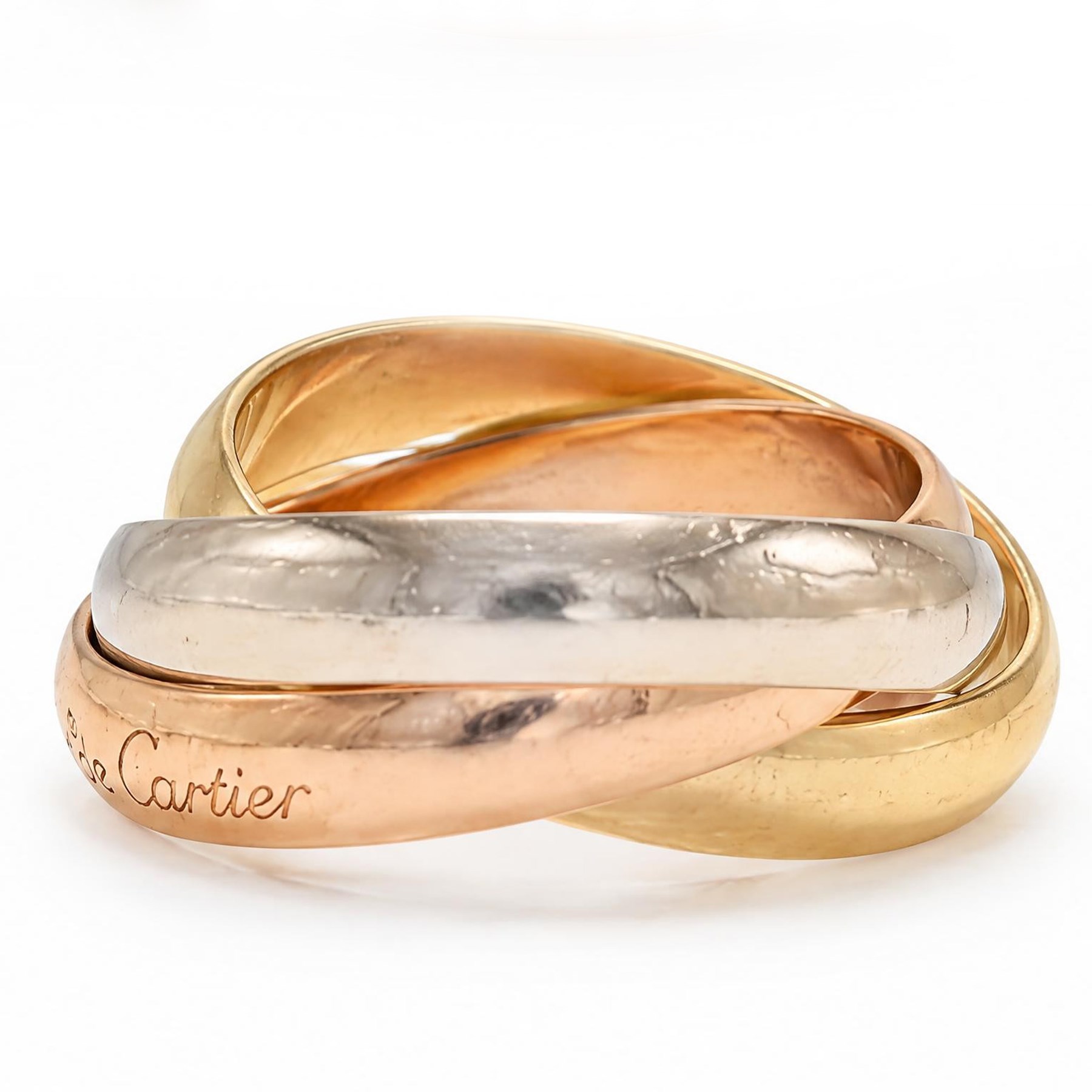 Les must de Cartier 18ct gold Trinity ring, with three interlinked rose, white and yellow gold bands, with certificate dated 1983