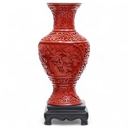 Three Chinese red and black cinnabar lacquered vases, together with three metalware examples, possibly 19th century Islamic, comprising vase, cup and covered vessel with floral handle; and a carved soapstone pig (7)