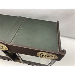 Early 20th century scratch-built wooden hat & gown shop diorama 'Joan', of double-fronted form glazed on three sides with brass and aluminium mounts, rear access apertures and storage under L63cm H45cm D31cm; with small collection of dresses and hats on display stands