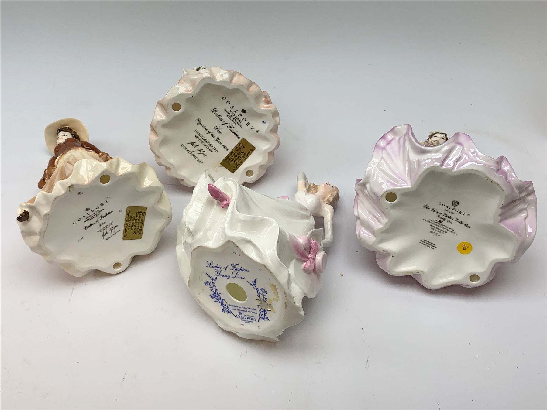 A group of four Coalport figurines, comprising limited edition The Flower Ladies Collection Lovely Iris, 90/250, with accompanying certificate, Ladies of Fashion Sue, with accompanying certificate, Ladies of Fashion Joan, and Ladies of Fashion Young Love, with one box.
