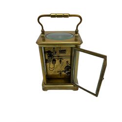 A late 19th century French corniche cased carriage clock with an eight-day movement and alarm sounding on a steel gong, with four glazed side panels and a glazed oval to the top, white enamel dial with Roman numerals, minute track, spade hands and alarm setting dial, with a cylinder platform escapement with slow/fast regulation. With Key



