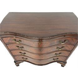 Chippendale design serpentine chest, shaped moulded top carved with repeating flower head motifs, fitted with brushing slide over four graduating drawers, pierced and foliate moulded handle plates with scrolled swan neck handles, canted upright corners carved with flower heads and strapwork, on canted ogee bracket feet