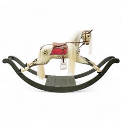 In the manner of F. H. Ayres - large carved wooden rocking horse, in dapple grey paint finish, decorated with glass eyes, leather reins, stirrup and saddle, on bowed rockers united by turned stretchers and boarded base 