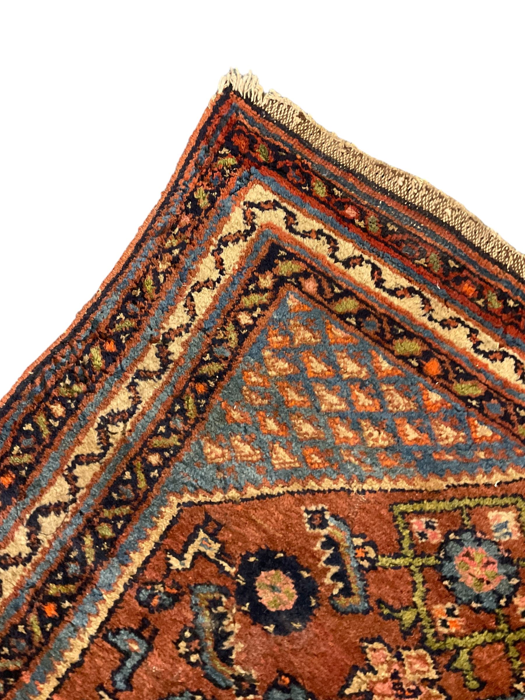 Small Persian rug or mat, decorated with Herati motifs within pattern borders 