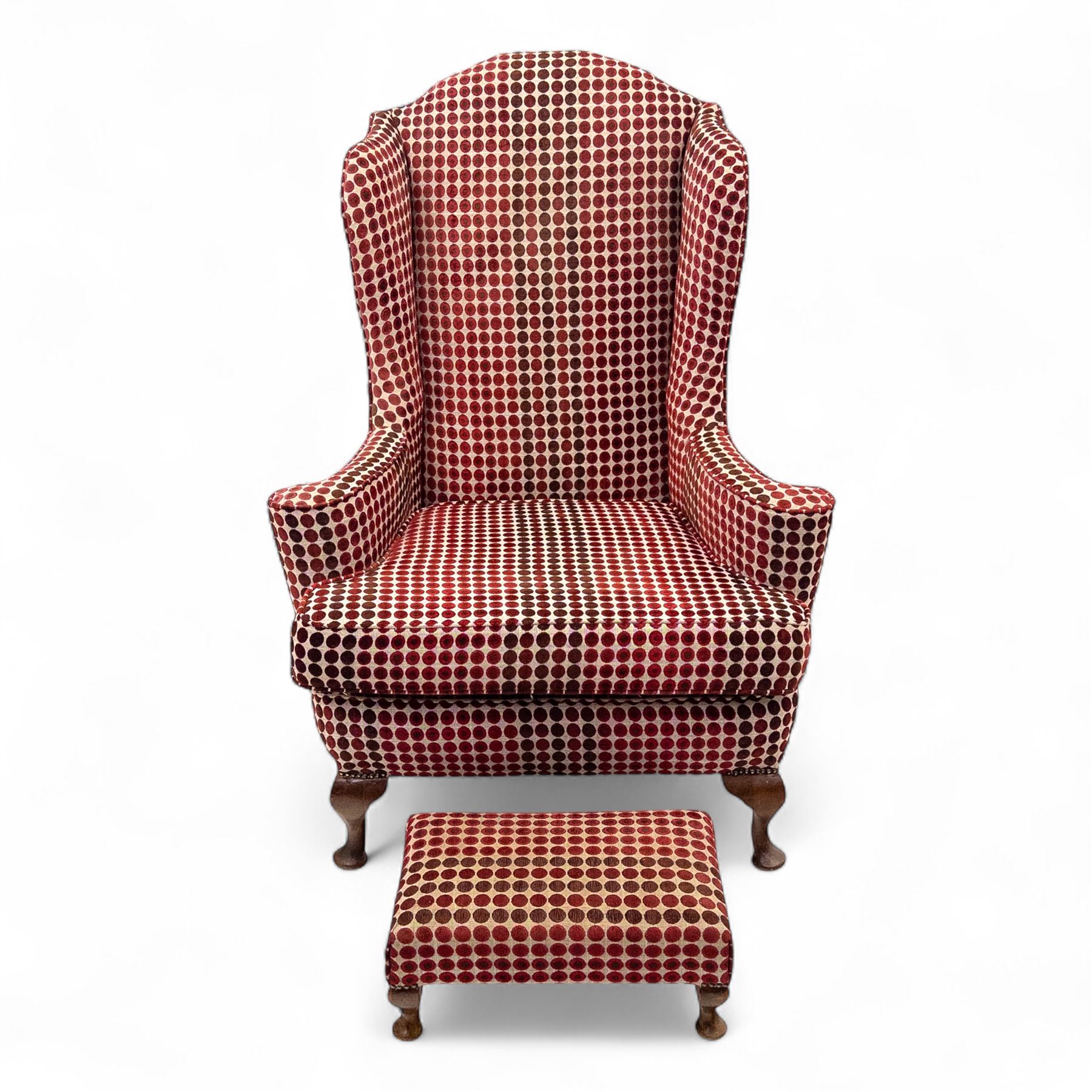 Late 20th century Georgian style wingback armchair with matching footstool, upholstered in red and cream geometric fabric, raised on cabriole front legs
