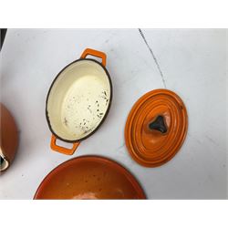Le Creuset 'Volcanic Orange' cast iron and enamel saucepans and two lidded casserole dishes  