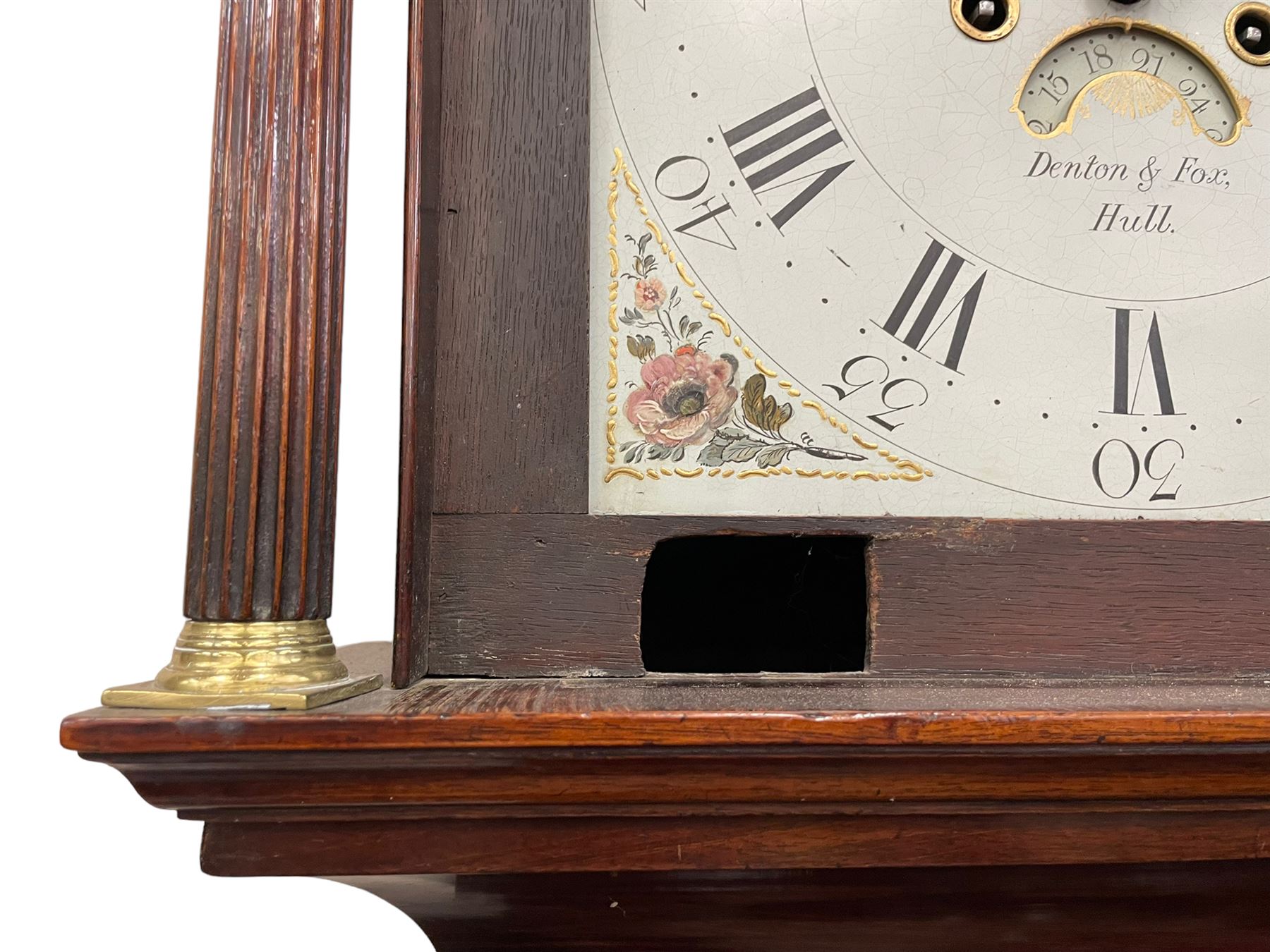 Denton & Fox of Hull – Early 19th century mahogany 8-day longcase clock c1802, pagoda pediment with an oval inlay and three ball and spire finials, break arch painted dial and hood door flanked by reeded pilasters with brass Corinthian capitals, long trunk door with conforming break arch top on a rectangular plinth raised on bracket feet, early Wilson (Birmingham) dial with Roman numerals, five minute Arabic’s and minute dots, subsidiary seconds dial and calendar aperture, with matching steel hands, floral spandrels within raised gesso work and a conforming oval depiction of a young maiden and dog to the break arch, dial pinned via a falseplate to a rack striking movement with a recoil anchor escapement striking the hours on a cast bell. With pendulum and weights.
Joseph Denton was a respected and prolific Hull clock maker working in Scale Lane Hull 1779 and Silver Street 1782-1814. Entering a short-lived partnership with Charles Fox from Beverley in 1802.
