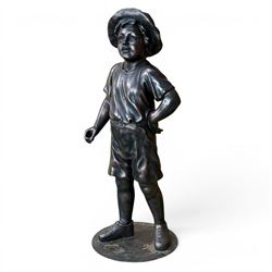 Bronzed composite figure of a boy wearing a hat, on circular plinth