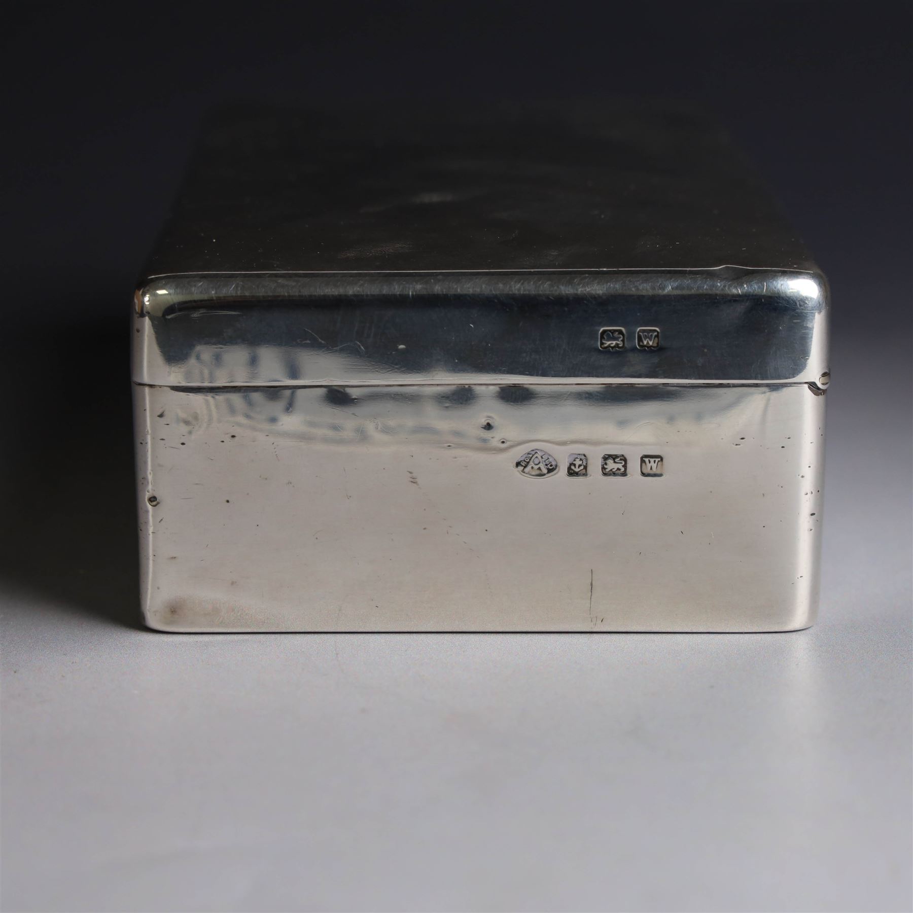 Mid 20th century silver mounted cigarette box, of rectangular form, with personal engraving to body reading 'Baron and Baroness Di San Marciano to Alan VG Bibby in grateful appreciation Malta April 1948, engraved with San Marciano family coat of arms to hinged cover, opening to reveal a softwood lined interior, hallmarked Adie Brothers Ltd, Birmingham 1946, H5cm, W16.5cm