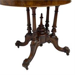Victorian figured walnut demi-dune card table, the fold-over moulded top with circular baize lining, on four turned pillars with central finial platform, four splayed moulded supports with angular scrolled feet, on castors