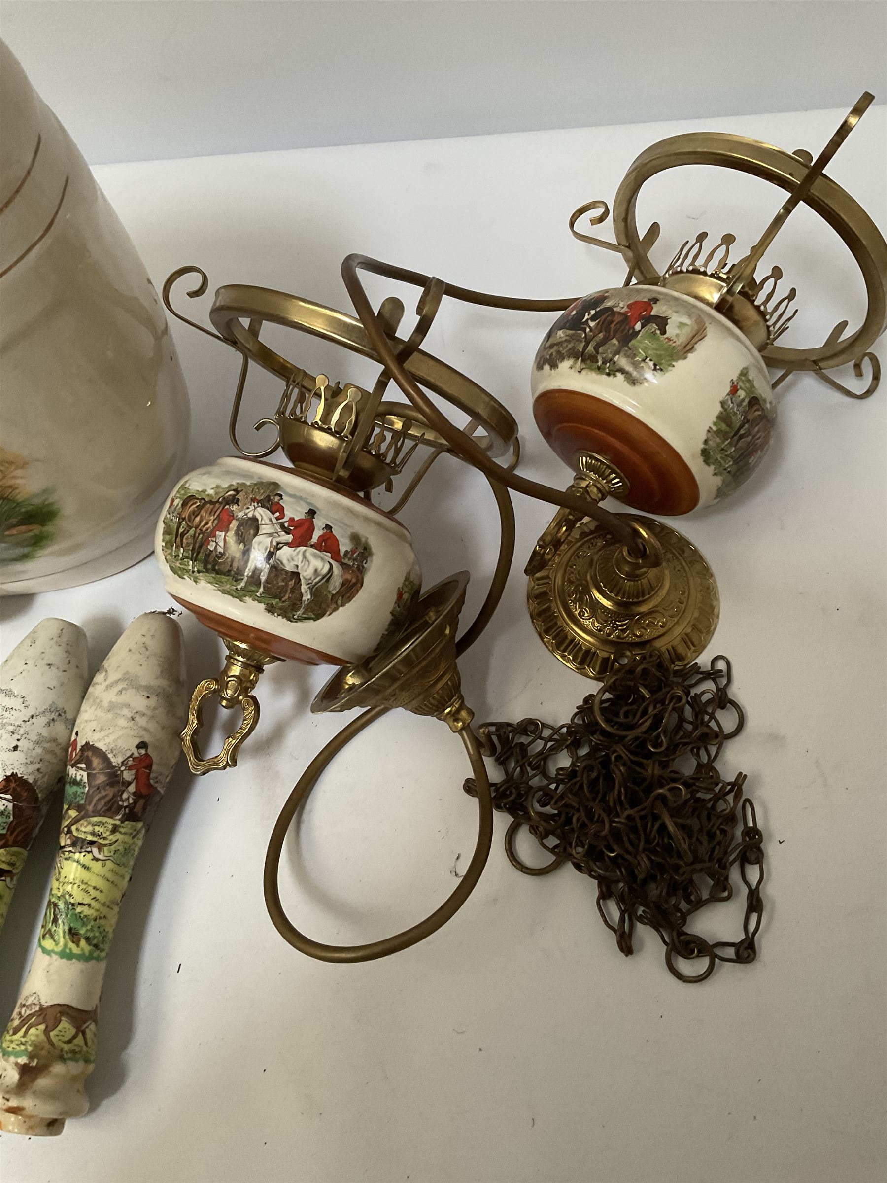 Ceramic hanging light fittings decorated with fox hunting scenes with brass fixtures, ceramic beer pulls decorated with hunting scenes and ceramic whisky barrel decorated with a pheasant