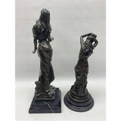 Two bronzed figures, the first modelled as a woman in chains, the second semi nude female with her arms raised above her head, largest H42cm