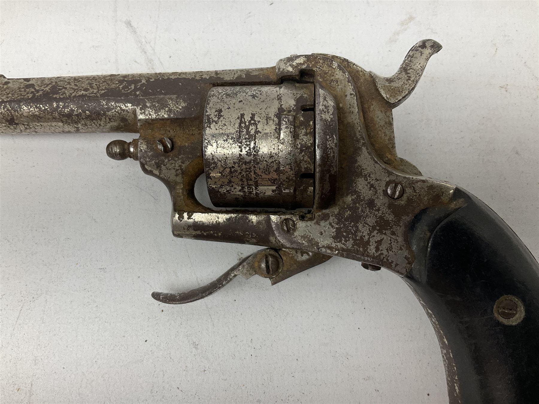 19th century 7mm six-shot pin-fire revolver, with folding trigger, two-piece ebonised grip and ejector rod in butt L17cm