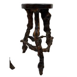Mid-20th century French grapevine and walnut bow-front wine tasting bar, the curved counter top supported by sculptural grapevine roots, fitted with single shelf and raised on rustic vine feet (W100cm H101cm); with a pair of matching bar stools, the circular top raised on three gnarled root supports united by stretchers (W50cm H70cm)