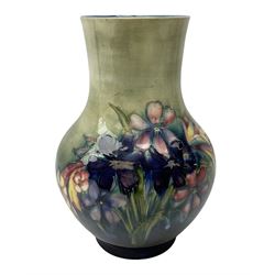 Moorcroft vase of baluster form decorated in the Spring Flowers pattern upon a merging green and blue ground, with impressed and painted marks beneath, H22.5cm