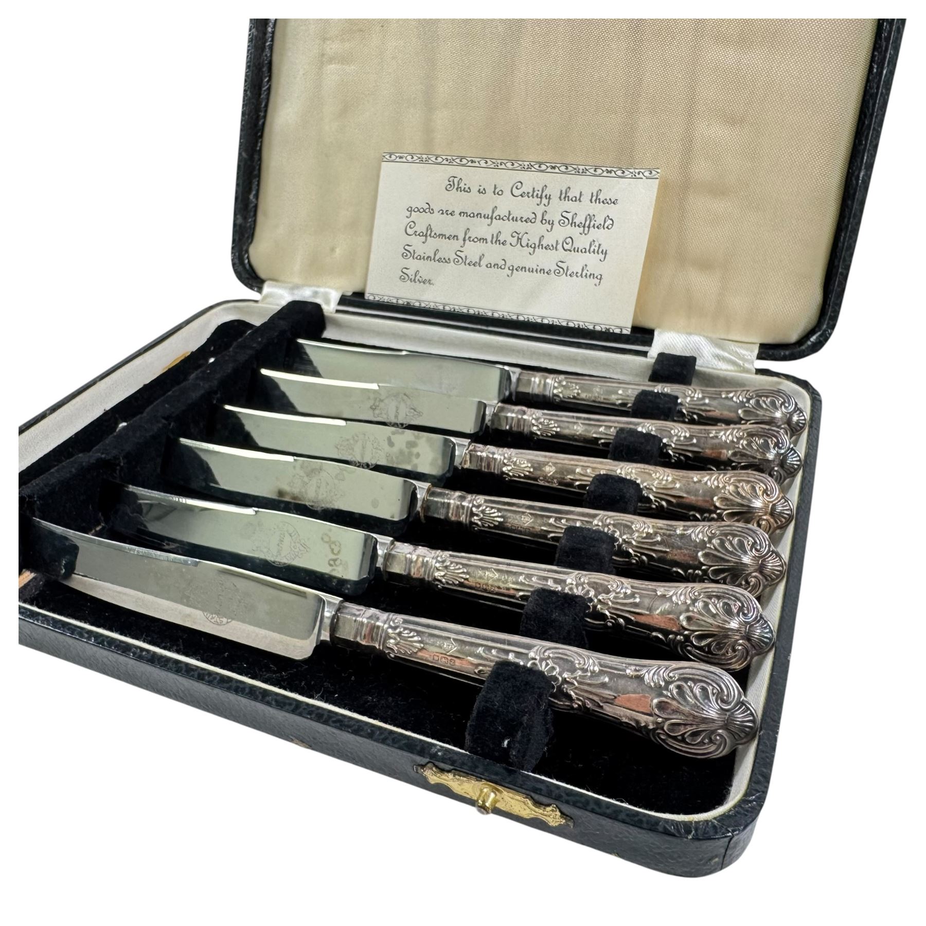 Two sets of cased silver handled tea knives, two silver mounted photo frames, silver mounted candlestick, silver ring holder with weighted base, silver mounted jewellery box