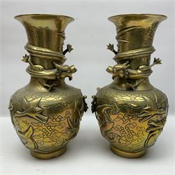 Pair of Chinese brass vases, of ovoid form with elongated neck and fluted rim, decorated in high relief with a dragon chasing a flaming pearl around the neck, the body with dragons, birds and buildings, with character marks beneath, H25cm