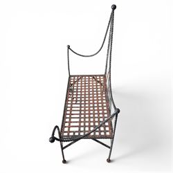 Victorian design wrought iron garden bench, with asymmetrical rope-twist frame, arched back and sides over out-swept arm terminals with ball finials, flanking a lattice seat, in antique black-painted weathered finish