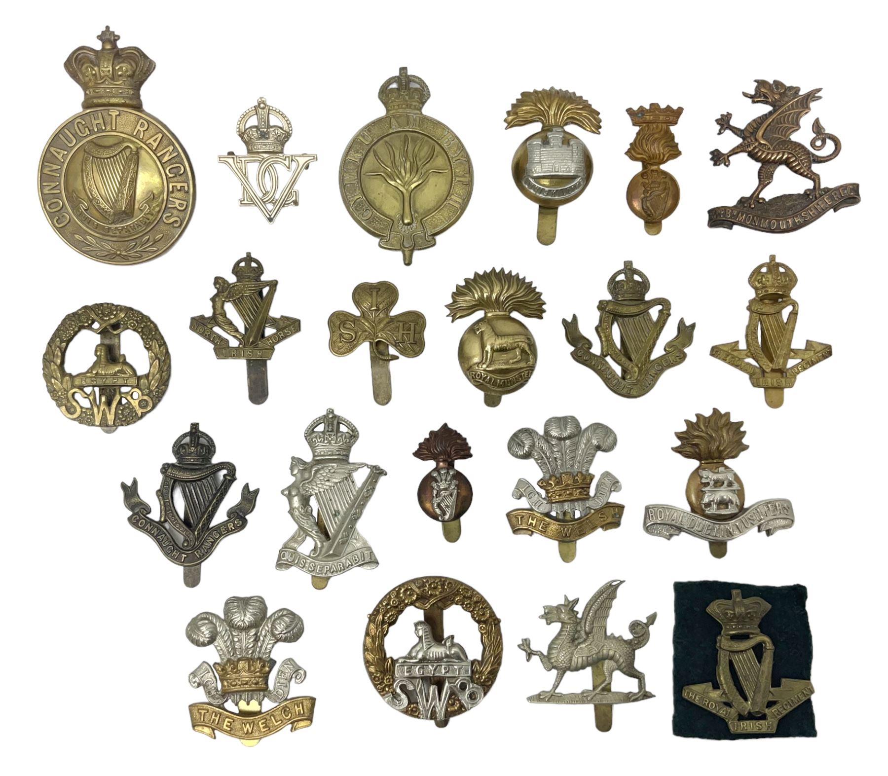 Fourteen cap badges of Irish interest including Royal Dublin Fusiliers inscribed to the slider 'From A. O'Connor 2nd Batt. Dec.2nd 1915', Connaught Rangers, South irish Horse Yeomanry, Inniskilling Fusiliers, Royal Irish Regiment etc; and seven Welsh badges including South Wales Borderers, Welsh Guards, 3rd Bn. Monmouthshire Regt. etc (21)