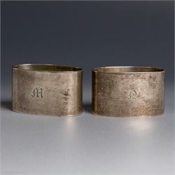 Two silver napkin rings, of oval form with engraved initials, both hallmarked