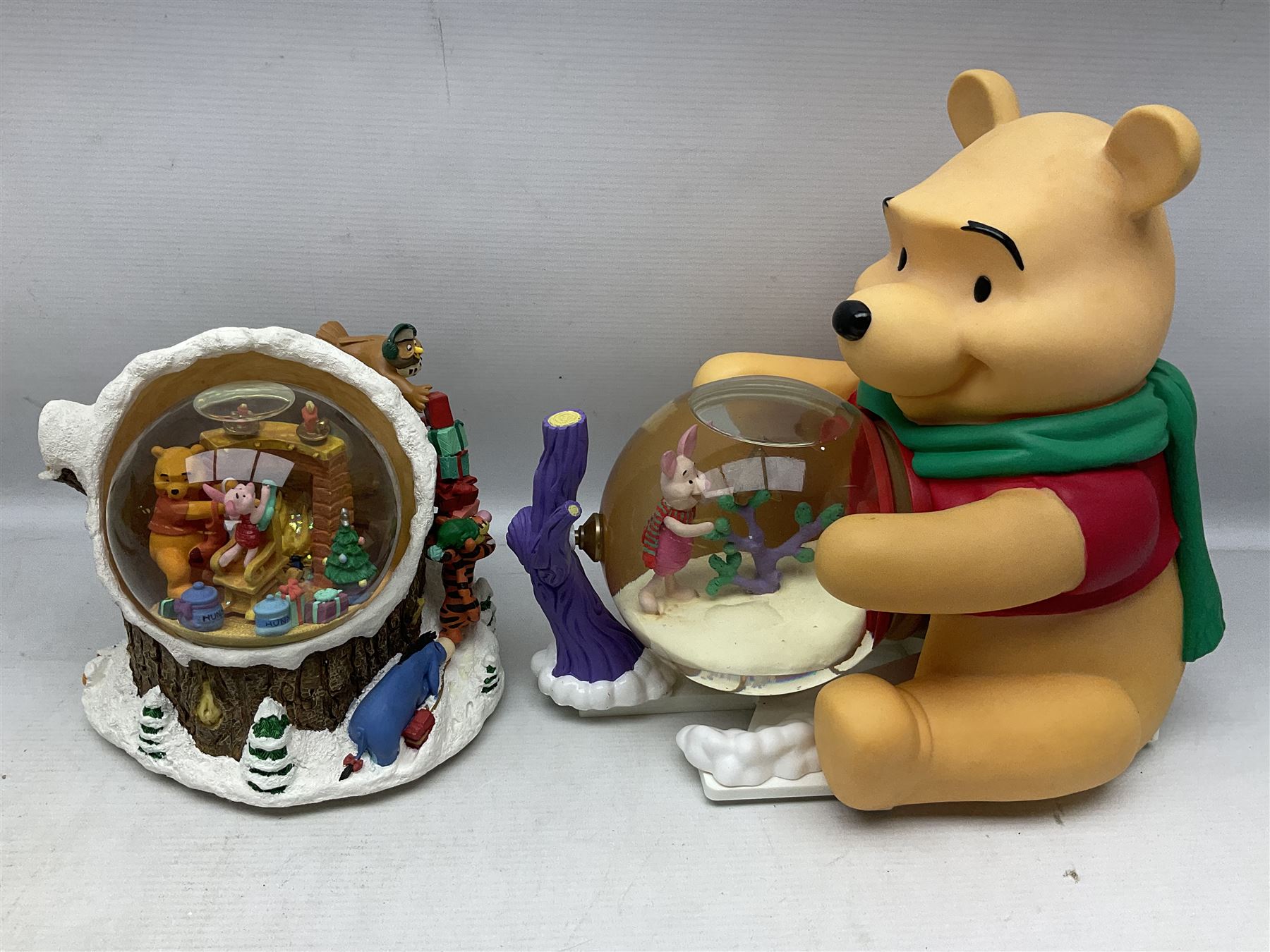 Six Disney Winnie the Pooh Christmas snow globes, comprising large Mr Christmas Holiday Snowfall, An Enchanted Christmas, It's A Small World Christmas 1994,  Tree Trimming, 1995 Christmas At Our House and Christmas Band Concert, together with Mr Christmas Holiday Go Round, all with boxes (7)