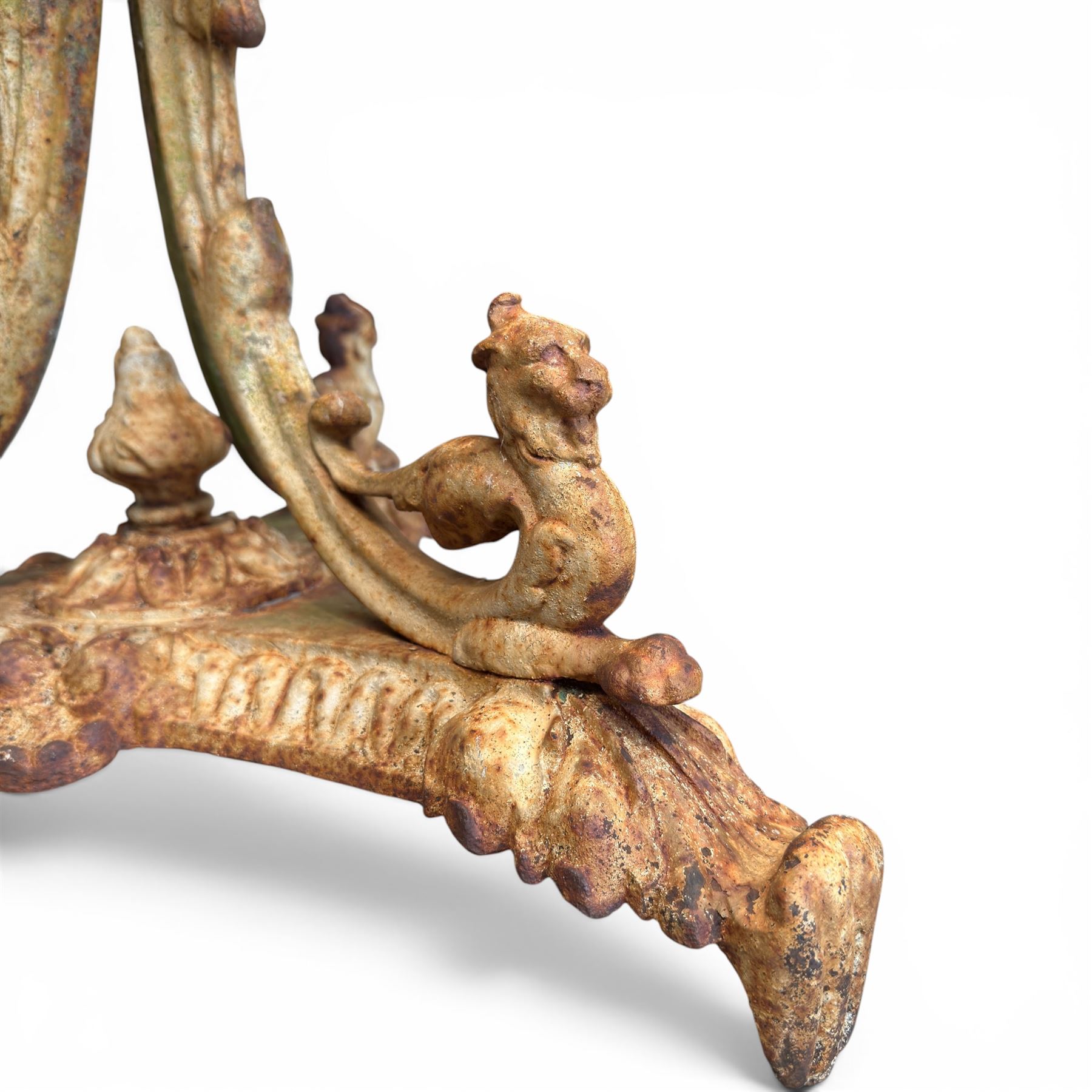 Victorian cast iron garden table, circular pierced top with foliate and scroll decoration, raised on an ornate tripod base with natural weathered paint finish.
