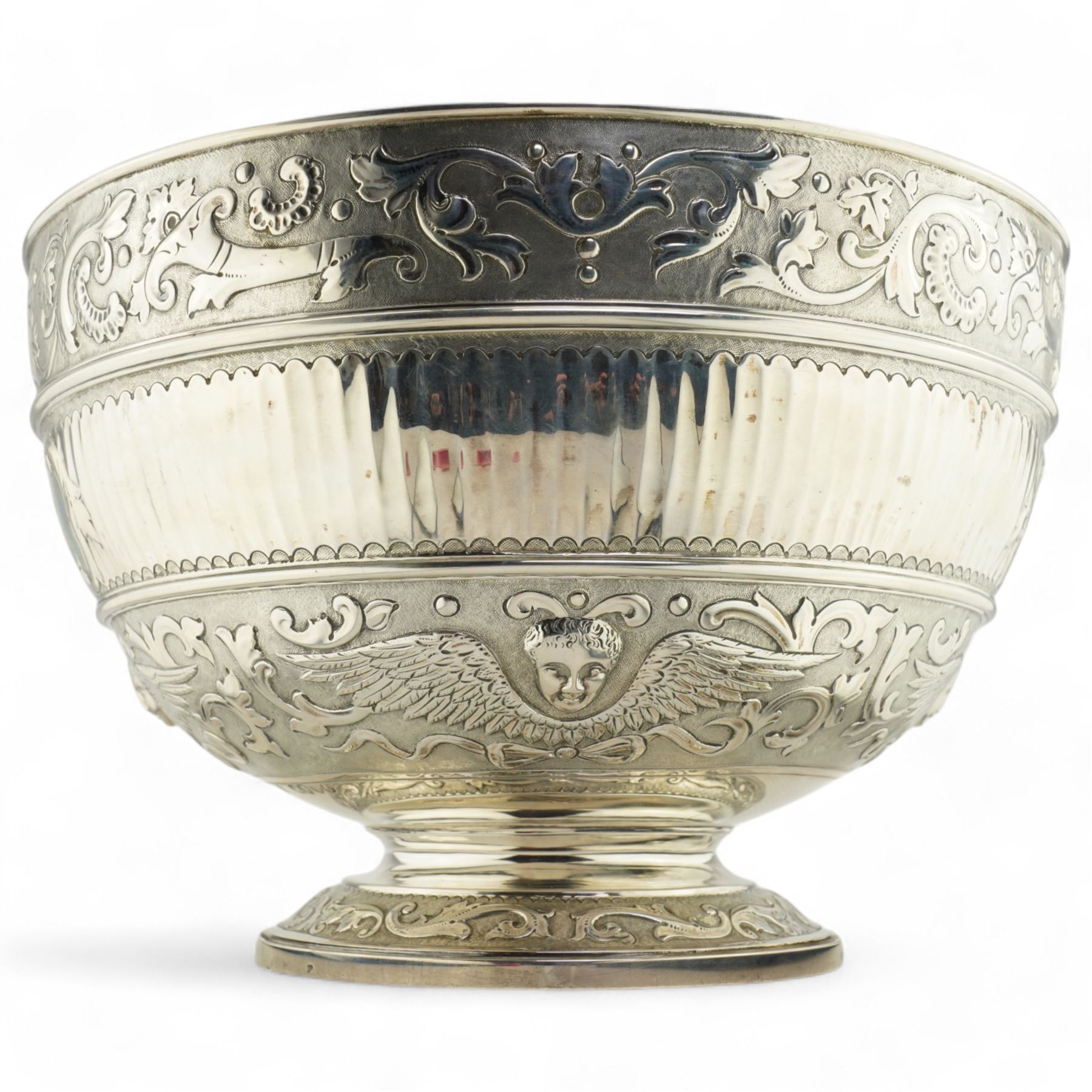 'Delwood Trophy in Memory of Col. H.H. Wilberforce' - A large Victorian silver rose bowl embossed with masks, wings, scrolls etc on a short pedestal foot D29cm London 1882 Maker Walter & John Barnard 