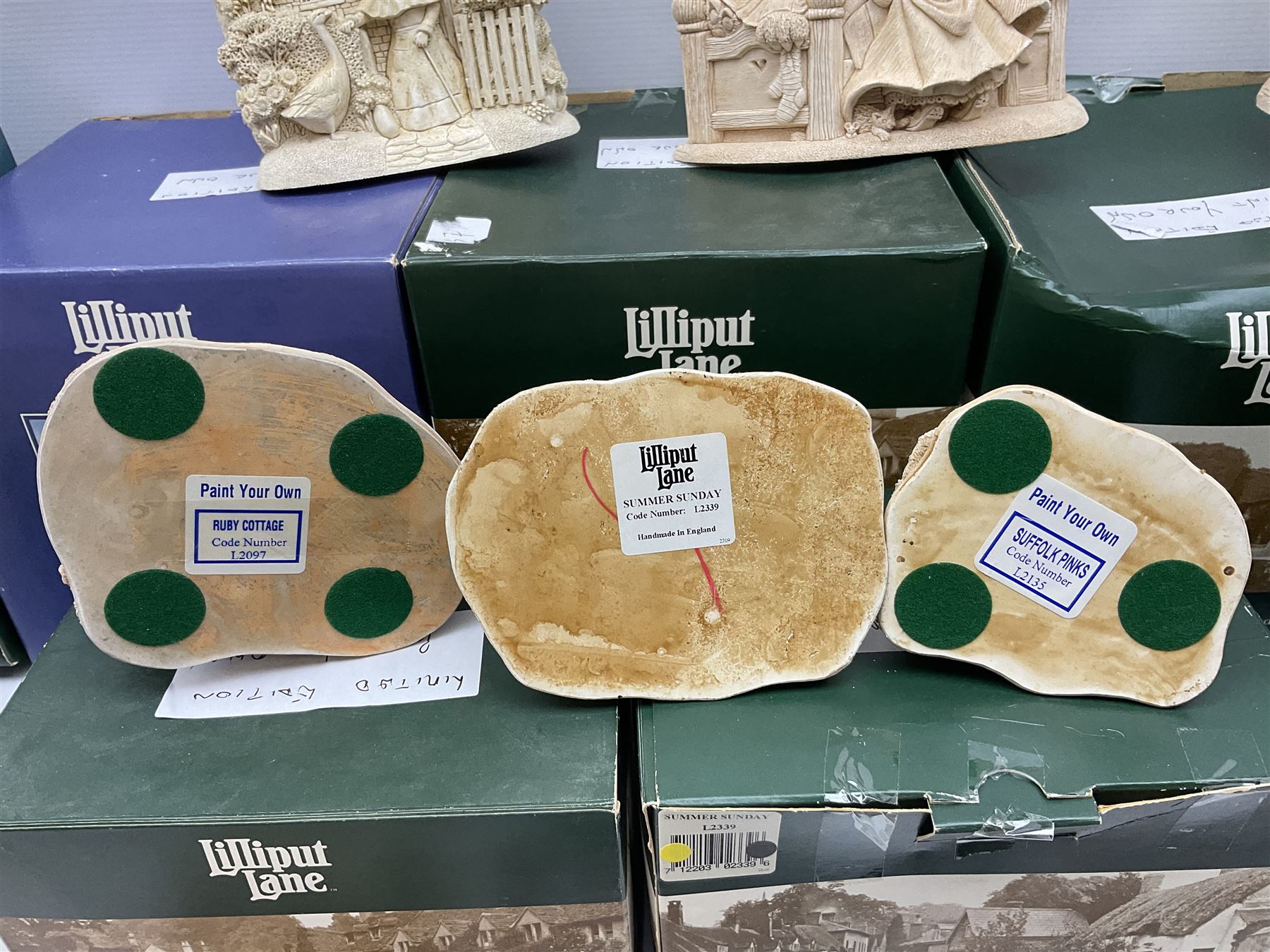 Ten Lilliput Lane models from the 'Paint Your Own' collection, to include cottages and plaques, all boxed, to include one boxed model with paints and brushes and a further box of paints